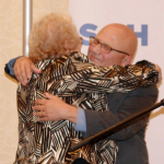Ruth Hollman hugs honoree Allen Berger.